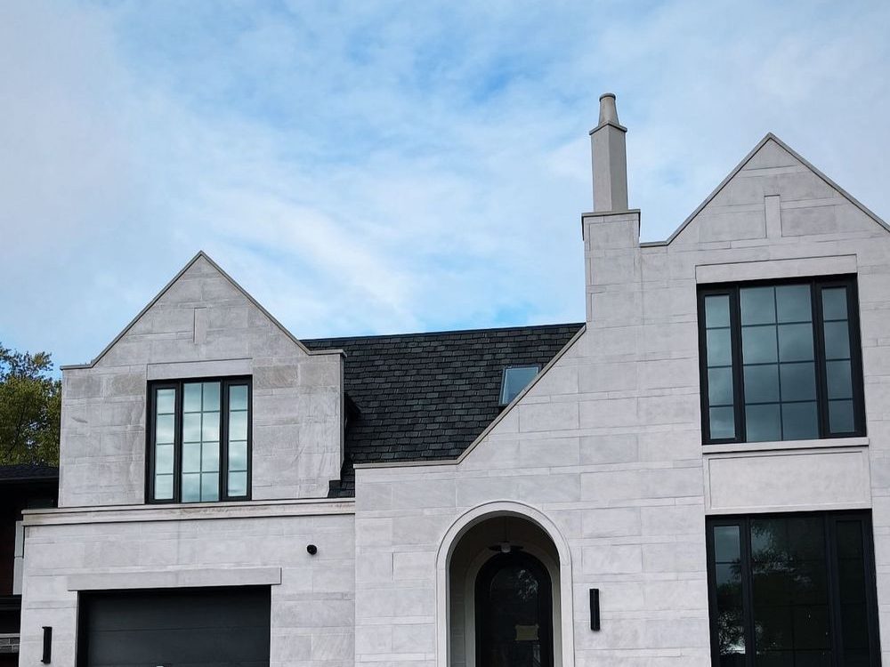 Transitional Tudor Revival with limestone façade