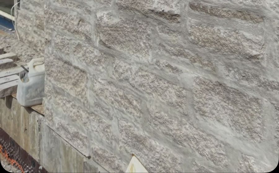 Buff tumbled limestone with a German smear mortar joint